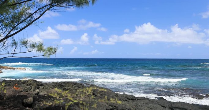 Scenic Hilo Hawaii rocky beach coast and surf. Destination for swimming, scuba and snorkel, underwater fish and coral. Big Island, largest, most volcanic active. Economy is tourism based. Water.