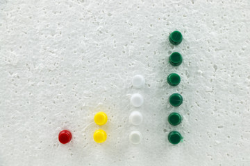 Fototapeta na wymiar Colorful pins on polystyrene business growth chart.