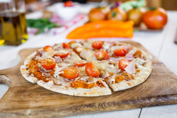 hot fresh homemade traditional italian pizza on wooden table. wallpaper for pizzeria and cooking food concept