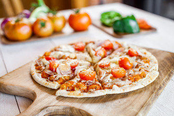 hot fresh homemade traditional italian pizza on wooden table. wallpaper for pizzeria and cooking food concept