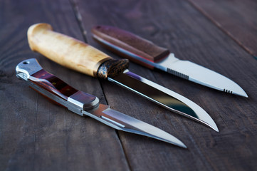 hunting knives on wooden background