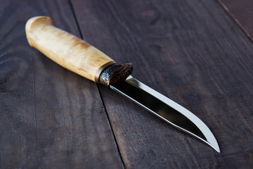 hunting knife on wooden background