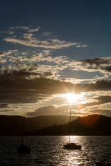 yachts docked at the pier in the Bay of Montenegro at sunset and mountain