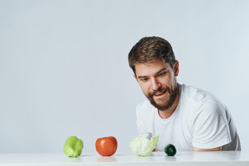 Fototapeta premium a man chooses what vegetables to eat