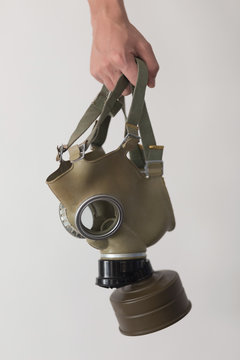 Young man holding a gas mask