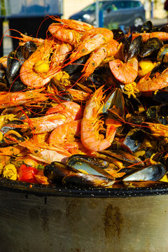 Fresh prepared traditional food - paella with schrimps, prawns, mussels on the street market