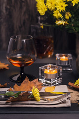 Table setting with autumn decoration for Thanksgiving.