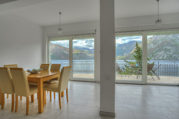Fototapeta premium Interior of a kitchen in a villa with beautiful sea and mountain view
