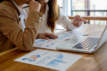 Business concept. Business people discussing the charts and graphs showing the results of their successful teamwork.