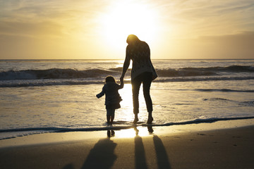 Mother And Daughter At Sunset On Beach - 177843521