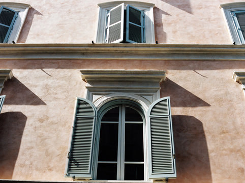 Looking up at shuttered windows in Rome