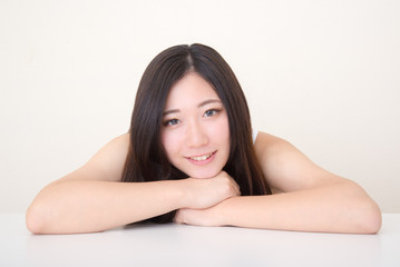 young asian woman posing at table