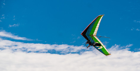 Hang Glider flying in blue sly