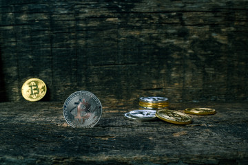 Many golden and silver bitcoins on a wooden surface, background with vintage effect, cryptocurrency concept for business idea, closeup, set