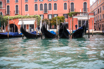 Obraz premium Venice, Italy - October, 2017: View from grand water canal with gondolas to old buildings in Venice, Italy the street in the old center.