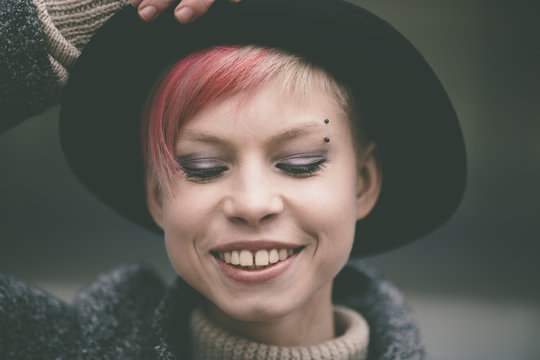 happy young woman with black hat
