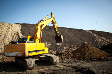 construction machinery at the construction site of the road in the quarry is gaining ground and...