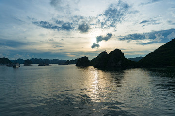 Dusk at Halong Bay with dark mountain island silhouettes