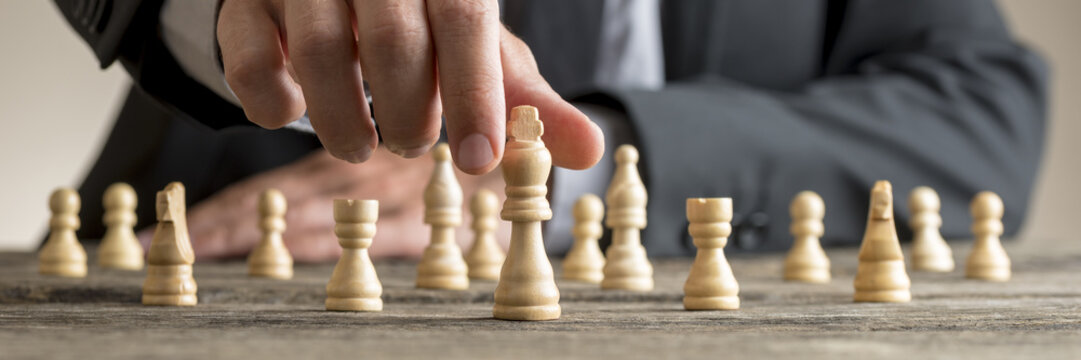 Wide cropped image of a businessman playing chess