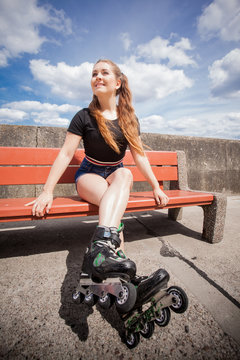 Young woman riding roller skates
