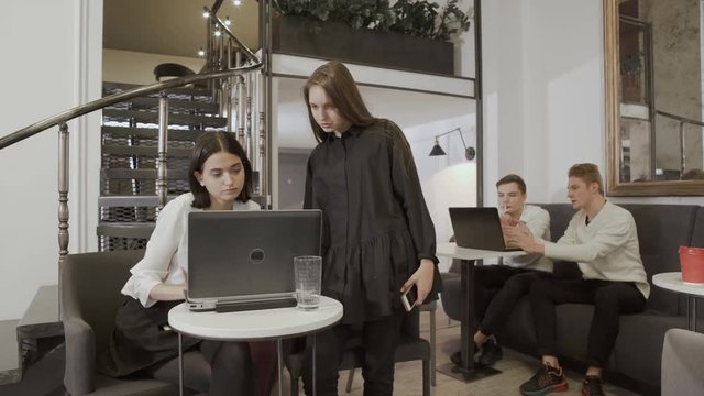 People thumb up to the camera in the co-working space