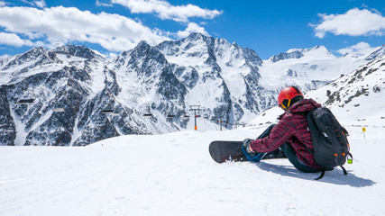 Fototapeta na wymiar Snowboarder preparing for a ride on glacier in Austria
