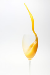 splash of orange juice in the glass on white background