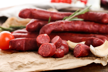 Delicious smoked sausages on parchment