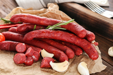 Delicious smoked sausages on parchment