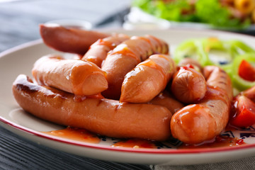Closeup of delicious grilled sausages on plate