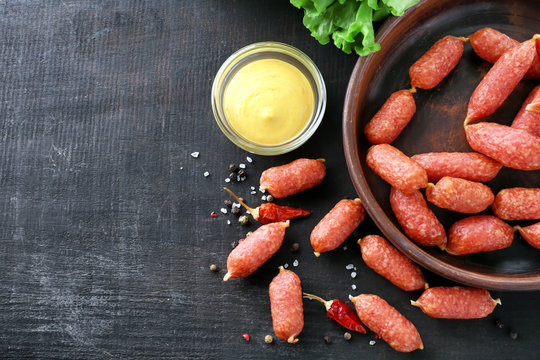 Delicious smoked sausages on wooden background