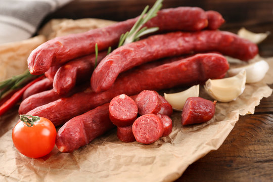 Delicious smoked sausages on parchment