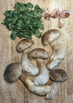 Food: Mushrooms, ceps with parsley and garlic on a cutting board