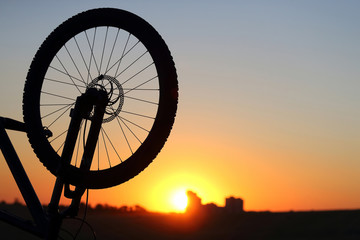 silhouette of a Bicycle wheel at sunset.