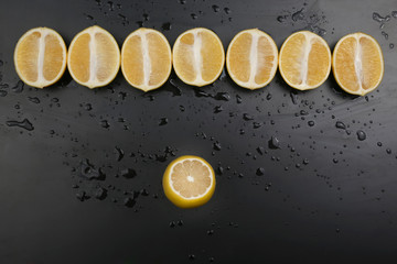 cut in half lemons on a dark background