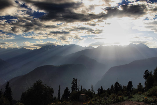 View of sunlight on mountain ranges during sunrise