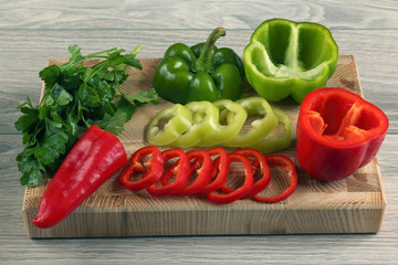 cut sweet pepper on wooden board