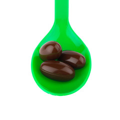 supplementary. vitamin E. eating. green spoon.  isolated on white background