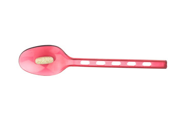 red spoon plastic with supplementary garlic  isolated on white background