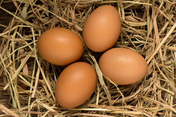 egg. straw. on wood