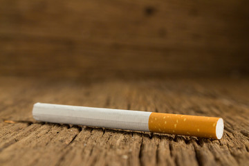 Tobacco cigarette on a  wooden