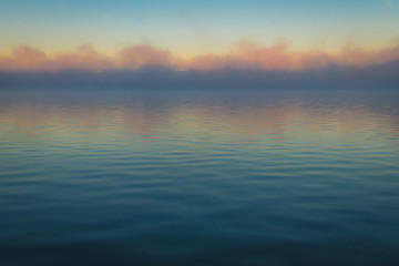 Obraz premium Fog creates a muted palette at dawn on Silver Lake, Castile, NY, in early fall