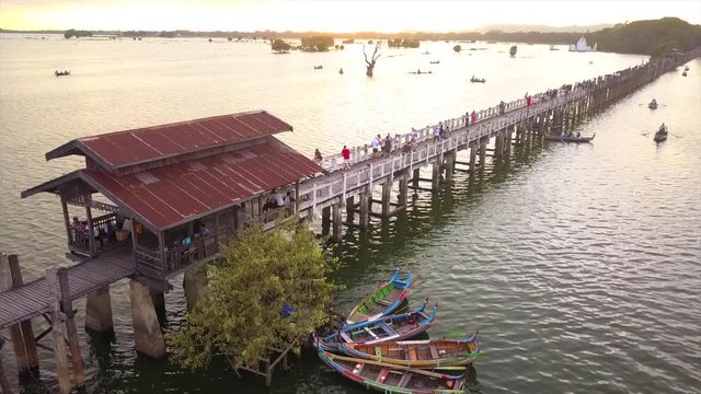 4K aerial view from the drone on the U Bein bridge, crossing that spans the Taungthaman Lake near Amarapura in Myanmar