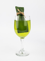 Pandan and pandan juice is made from the crushed or boiled. It health drink in clear glass.isolate on white background