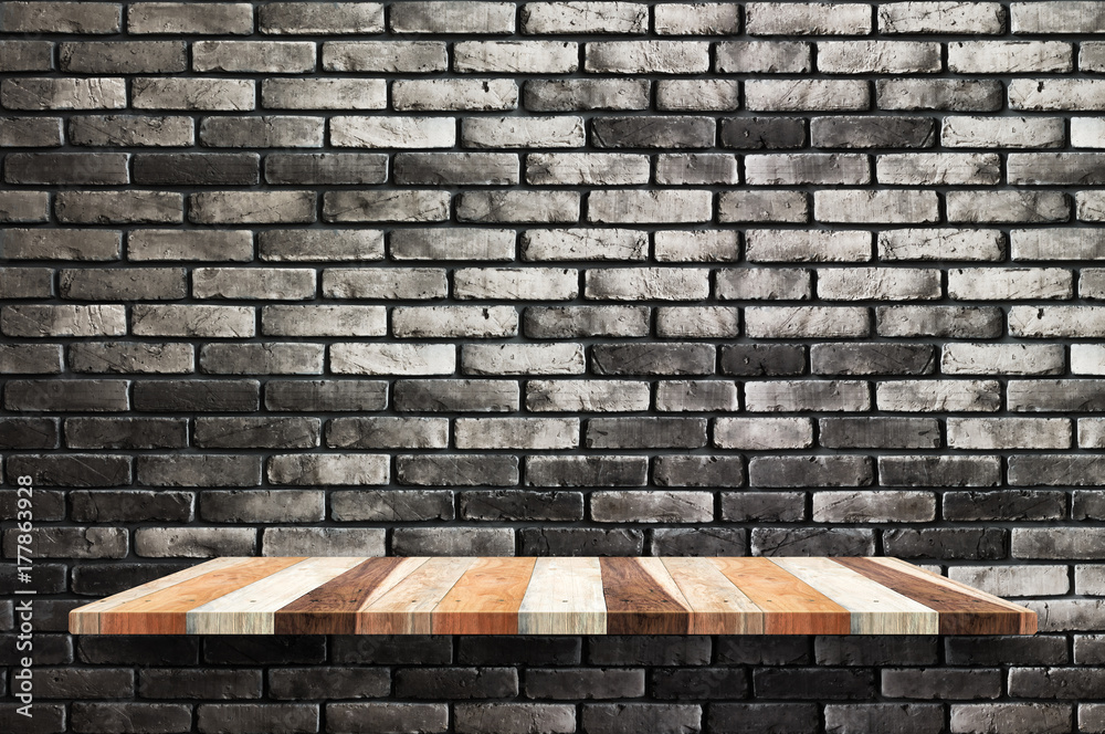Poster empty wood board shelf at black brick wall background,mock up for display or montage of product or d