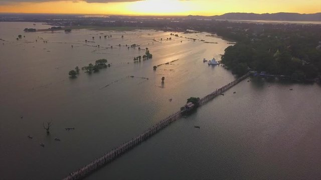 4K aerial view from the drone on the U Bein bridge, crossing that spans the Taungthaman Lake near Amarapura in Myanmar