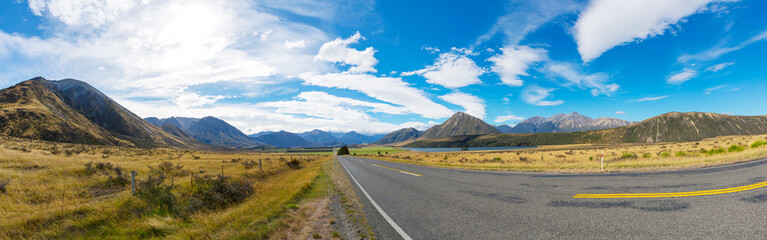 Fototapeta na wymiar Rural Scene of Asphalt Road with Meadow and Mountain Range, South Island, New Zealand 