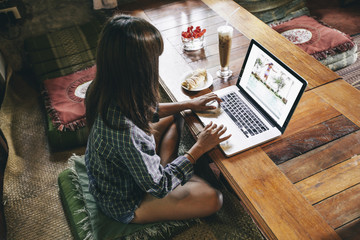 Woman Working With Photos on Her Laptop
