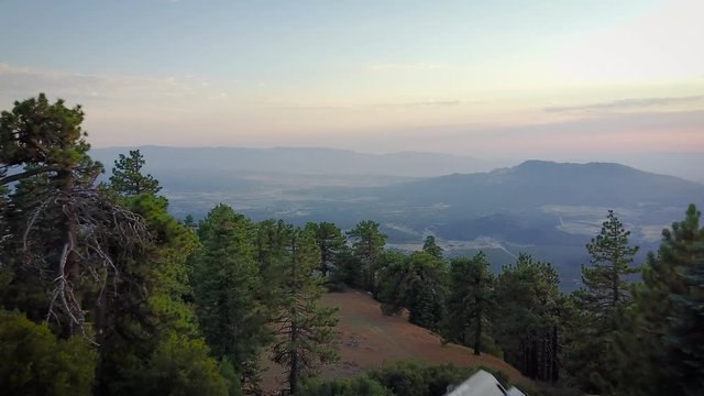Drone pull to reveal people camping on top of a ridge with an epic view.