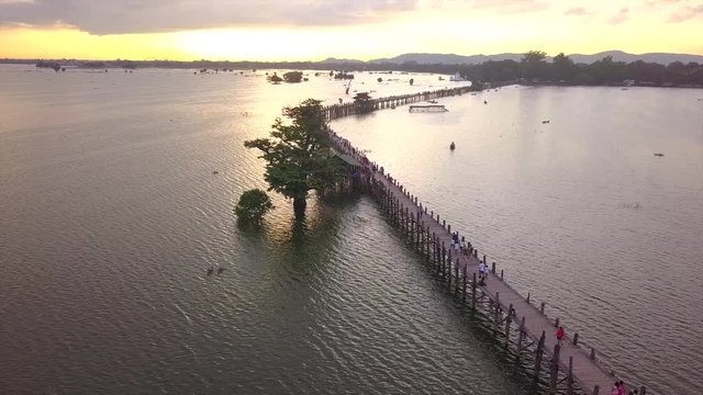 4K aerial view from the drone on the U Bein bridge, crossing that spans the Taungthaman Lake near Amarapura in Myanmar